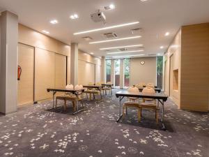 a row of tables in a room with windows at ibis Styles Tallinn in Tallinn