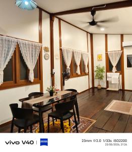 a living room with a dining room table and chairs at Ciao Bella in Dungun