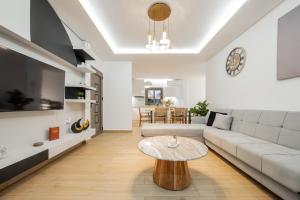 a living room with a couch and a table at Villa Lux Stana in Zakynthos