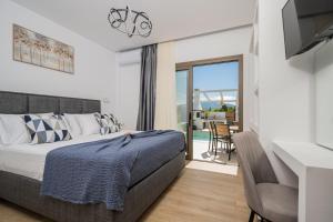 a bedroom with a bed and a balcony at Villa Lux Stana in Zakynthos +43 photos