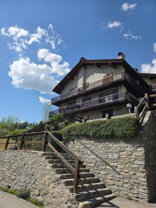 a building with a stone staircase in front of it at L'Atelier du Temps - Moline Paradiso in Cogne