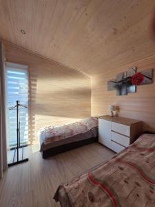 a room with two beds and a cross on the wall at Zacisze in Józefów