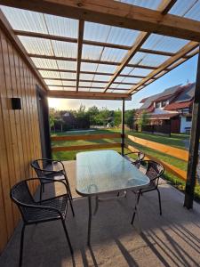 a table and chairs on a patio with a pergola at Zacisze in Józefów