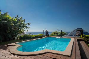 a swimming pool with a view of the ocean at Villa Le Nid des Colibris in Gourbeyre