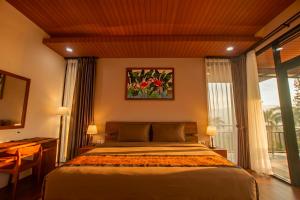 a bedroom with a bed and a large window at Villa Favore in Puncak +38 photos