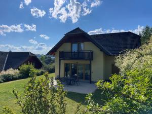 a house with a patio in the yard at LIPNO Hideaway in Kramolín