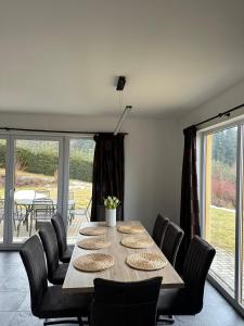 a dining room with a long table and chairs at LIPNO Hideaway in Kramolín +39 photos