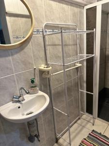 a bathroom with a sink and a mirror at Lodge Tainas in Faaa