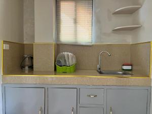 a kitchen with a sink and a counter top at ZM Residence in Dapa