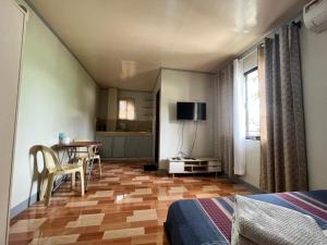 a bedroom with a table and a room with a bed at ZM Residence in Dapa