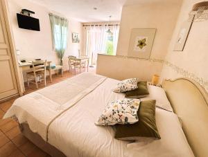 a bedroom with a large bed with pillows on it at La Résidence du Moulin in Tourrettes-sur-Loup