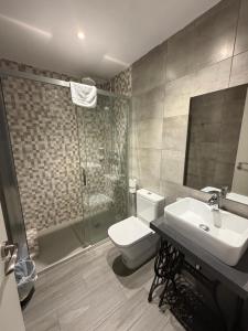 a bathroom with a toilet and a sink and a shower at Pensió Costa Brava in Sant Antoni de Calonge