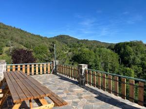 a wooden bench sitting on top of a wooden bridge at Chez Albert, in Saint-Ilpize +3 photos