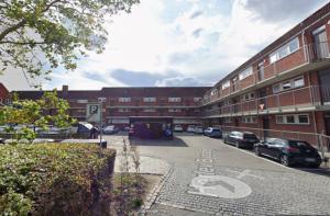 a parking lot with cars parked in front of a building at Go Hotel Herlev in Herlev