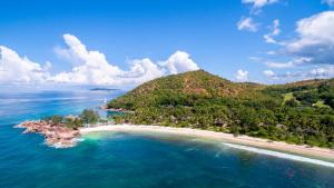 an aerial view of an island in the ocean at Constance Lemuria in Grand'Anse Praslin