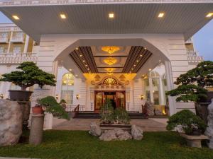 a large white building with trees in front of it at HOTEL VAN GOGH in Candon