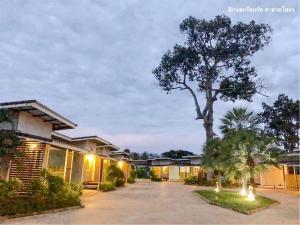 a house with a tree in the middle of a driveway at Zigzag Resort in Yasothon