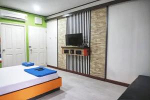 a bedroom with a bed and a flat screen tv at Zigzag Resort in Yasothon +54 photos