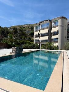 a large swimming pool in front of a building at Vila Marjana in Sarandë