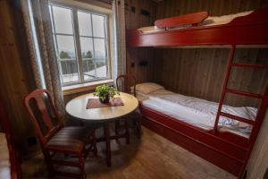 a small room with a table and bunk beds at Karstenstua in Holo +27 photos