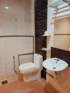 a bathroom with a toilet and a sink at One World Lodging in Bentong