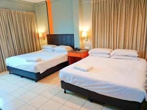 a hotel room with two beds in a room at One World Lodging in Bentong +54 photos