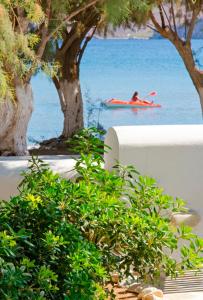 a person in a red kayak in the water at Mouras studios in Livadi Astypalaias