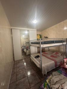 a small room with two bunk beds in it at Lodge Tainas in Faaa +9 photos