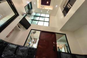 a living room with a couch and a ceiling with windows at Ecoland 88 Apartelle and Suite near SM Davao in Davao City