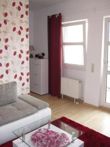 a living room with a couch and a window at APARTHOTEL 1A in Zwickau