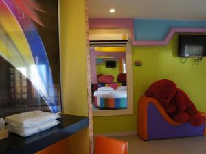 a childs bedroom with a bunk bed and a teddy bear in a chair at Fancy Resort in Ban Samran
