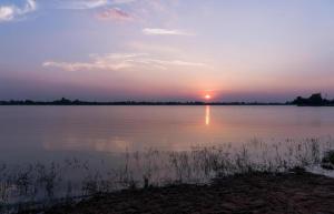 a sunset over a large body of water at Fancy Resort in Ban Samran +30 photos