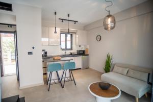 a kitchen and living room with a couch and a table at Evaeri Suites in Mytikas