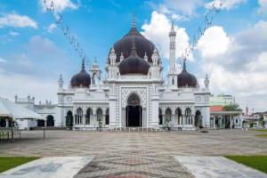a large white building with domes on top at BB Motel in Alor Setar