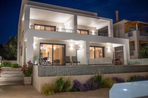a villa with a view of the night at Evaeri Suites in Mytikas