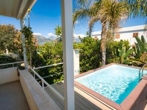a hot tub on the balcony of a house at CasaSol Deluxe villa sulla Spiaggia con Piscina e Jacuzzi By Sicily Home Solutions in Alcamo