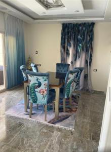 a dining room with a table and chairs at Alshrooq Village 97 in Borg El Arab