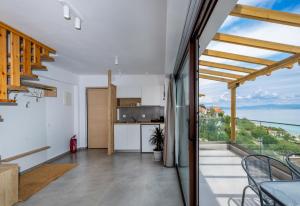 a kitchen and dining room with a view of the ocean at Grande Blu by NG Villas in Afitos +53 photos