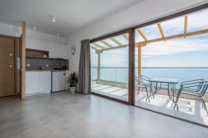 a kitchen and dining room with a view of the ocean at Grande Blu by NG Villas in Afitos
