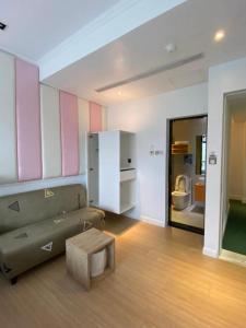 a living room with a couch and a coffee table at Read River in Anping