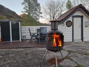a fire oven in front of a house at The Old Cabin in Vikedal