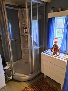 a bathroom with a shower and a sink at The Old Cabin in Vikedal +44 photos
