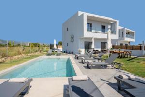 a villa with a swimming pool in front of a house at Villa Lux Stana in Zakynthos