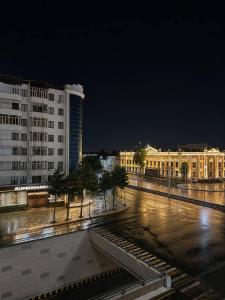a view of a city at night with buildings at Runa modern flat in Samarkand
