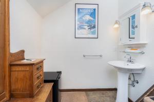 a bathroom with a sink and a mirror at Manitou Lodge 8 by Alpine Lodging Telluride in Telluride