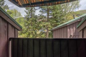 a wooden fence in front of a barn at Manitou Lodge 8 by Alpine Lodging Telluride in Telluride +9 photos