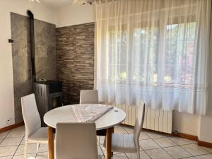 a dining room with a table and chairs and a window at Avventura e Relax a Bagnasco 1 in Bagnasco
