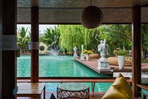 a view of a pool from a room with a table and chairs at S Garden View Resort in Ban Bang Yai Chuai