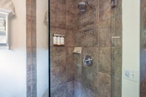 a bathroom with a shower with a glass door at Manitou Lodge 3 by Alpine Lodging Telluride in Telluride