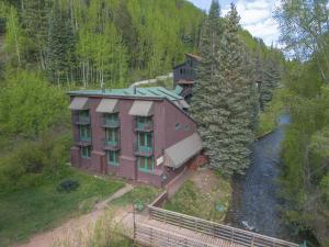 an aerial view of a building in the woods at Manitou Lodge 3 by Alpine Lodging Telluride in Telluride +8 photos